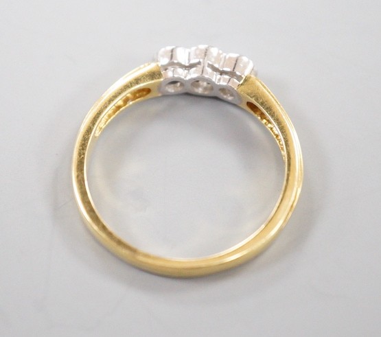 A modern 18ct gold and collet set three stone diamond ring, size P, gross weight 3.6 grams